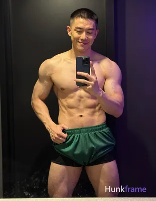 Asian man with short buzz cut and clean-shaven face smiling relaxed in a tastefu