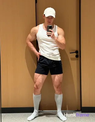 Candid iPhone selfie of a handsome muscular man with light-medium skin and short dark hair under a w