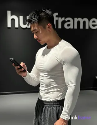 Asian man with short spiky black hair and faded undercut, clean-shaven chin with light upper lip stu