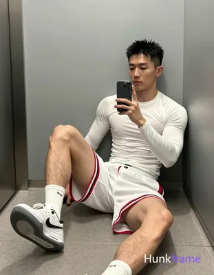 Asian man with short black textured spiky hair and clean-shaven face, lean build in white long-sleev
