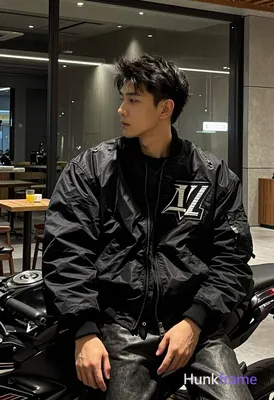Asian man with light to medium tan skin and short dark black tousled hair, clean-shaven face in a ne