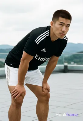 Asian man with short buzz cut and matte dark brown hair, clean-shaven face, neut