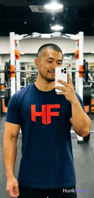 Asian man with medium-tan skin and short buzz cut, light stubble on jawline hold