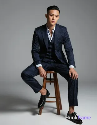 Asian man with short black side-parted slick-back hair and clean-shaven face, co