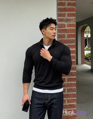 Asian man, light-medium skin, short textured black hair styled upward at the crown with tapered side