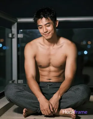 Asian man with tanned skin and short black hair slightly damp at the top, light 