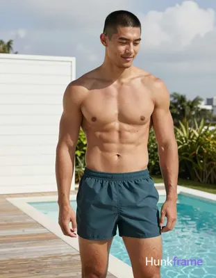 Asian man with short black buzz cut and clean-shaven face, light tan skin smiling gently while looki