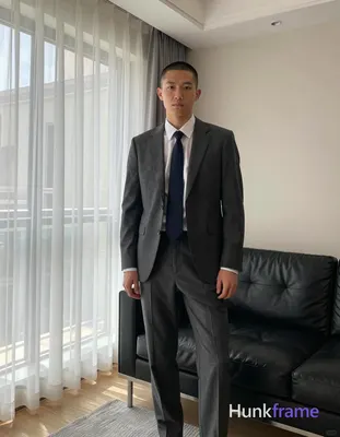 an anonymous figure man with short buzz cut and clean-shaven face, neutral intense gaze standing in 