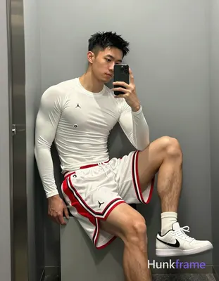 Asian man with light-medium skin and short black textured spiky hair, clean-shaven face in mirror se