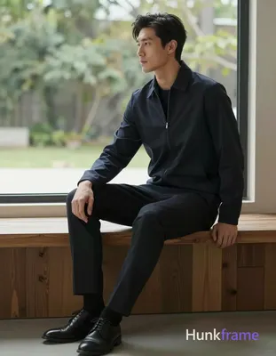 Asian man with fair skin and black short hair styled back with volume at crown, 