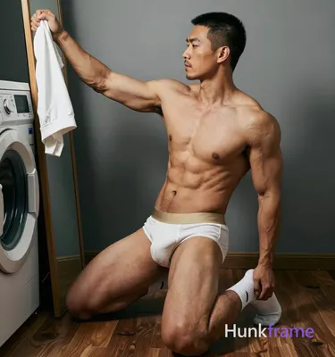 Asian man with medium-tan warm skin, short black buzz cut and clean-shaven chin with light upper lip