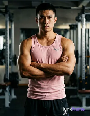 Asian man with medium-tan skin and short black crew cut, clean-shaven face, dire