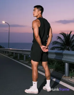 Asian man with medium-tan skin and short black buzz cut, clean-shaven face, neutral contemplative ga