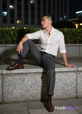 Asian man with short black side-parted slick-back hair and clean-shaven face, neutral expression mou