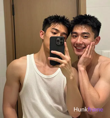an anonymous figure men in a mirror selfie composition, left side of frame dominated by subject one 