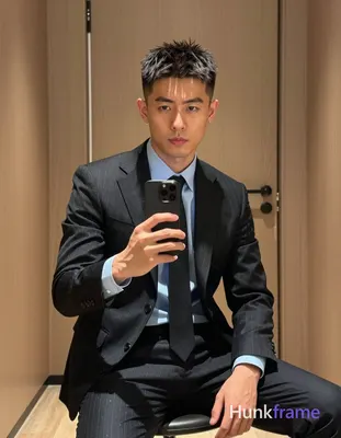 Photograph of exactly 1 adult man. Man 1: Asian, light to medium tan, oval with defined jawline and 