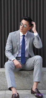 Asian man in light gray suit jacket and trousers, white dress shirt under single