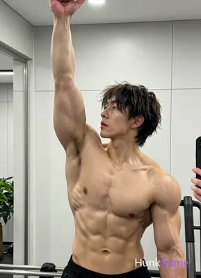 Asian man with short dark brown hair and straight texture Shirtless athletic build with defined pect