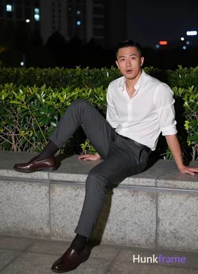 Asian man with short black side-parted slick-back hair and clean-shaven face, ne
