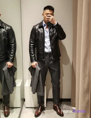 Asian man in muscle bear photography, standing upright facing a full-length mirr