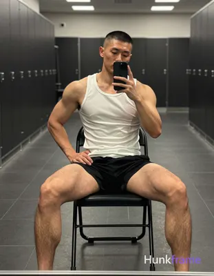 an anonymous figure man with short buzz cut and clean-shaven face, shirtless wea