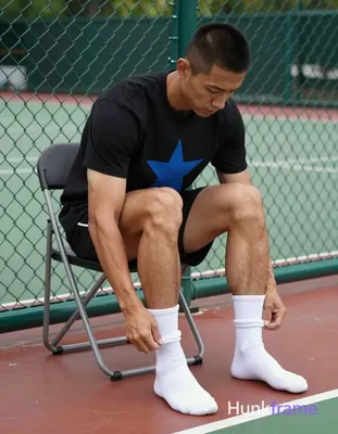 an anonymous figure man with light to medium tan skin and short black buzz cut sits on a folding cha