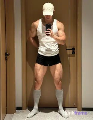 Full-body vertical shot of a muscular man with light-medium skin and short dark 