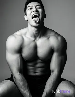 a shirtless man with broad shoulders and thick muscular thighs sitting down with