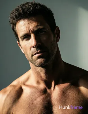 Adult man with dark brown short textured hair and light to medium skin, shirtles