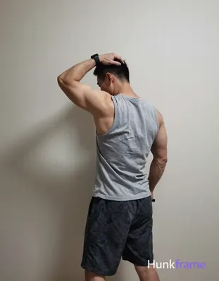 Striking full-bleed vertical wallpaper composition of a muscular adult man stand