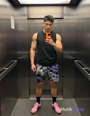 Asian man with medium-dark skin and short black straight hair stands in a full-b