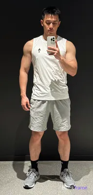 A handsome masculine man as a Xiaohongshu fitness influencer in a candid iPhone 