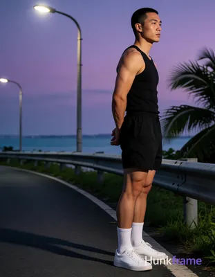 Asian man with short buzz cut and clean-shaven face stands sideways in a bold fl