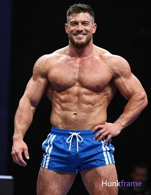 A big and hairy stocky adult man with tanned skin, short dark hair styled on top and faded sides, cl