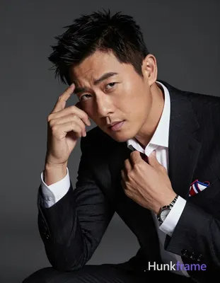 Asian man with fair to light tan skin and black short textured hair featuring side-swept fringe, cle