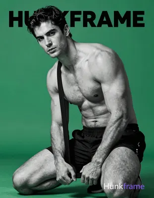 A handsome adult man with dark, short slightly wavy hair and clean-shaven face s