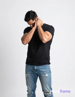 Full-bleed vertical phone wallpaper of an adult man with short black hair and defined biceps standin