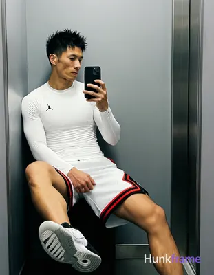 Asian man with light-medium skin and short black textured spiky hair, clean-shaven face in mirror se