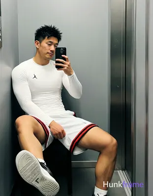 Asian man with light-medium skin and short black textured spiky hair, clean-shaven face in mirror se