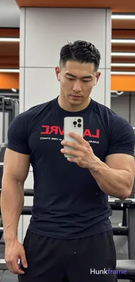 Asian man with medium-tan skin and short buzz cut, textured fade on sides and ba