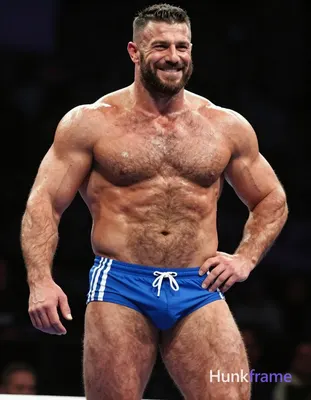 A big and hairy stocky adult man with tanned skin, short dark hair styled on top and faded sides, cl