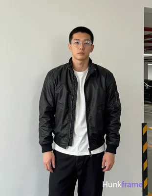 Asian man with short black flat-top hair under cap, rimless thin metal frame gla