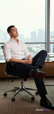 an anonymous figure man in his 30s with light to medium skin and a short black buzz cut, clean-shave