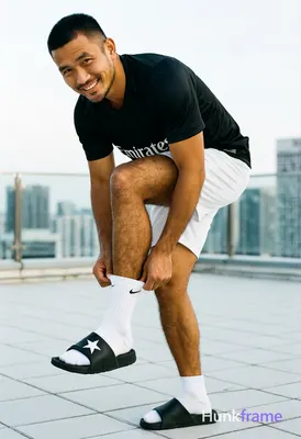 Asian man with medium-tan skin and short black buzz cut, clean-shaven face with 