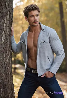 Handsome athletic man with curly brown hair, blue eyes, light skin, short beard 