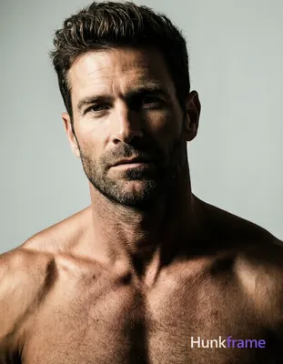 A handsome adult man with light to medium skin, dark brown short textured hair s