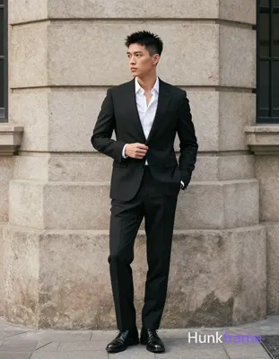 Asian man with short textured black hair styled upward and back, clean-shaven face, neutral composed