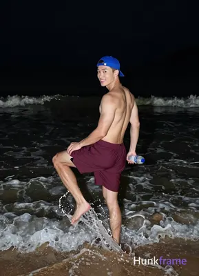Asian man in high-contrast night photography, shirtless adult bare chest standin