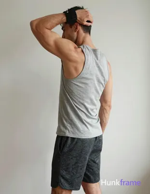 A handsome masculine man in a premium fashion editorial, standing in profile wit