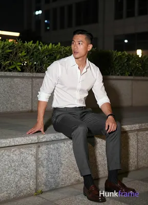 Asian man with short black side-parted slick-back hair and clean-shaven face, neutral expression mou